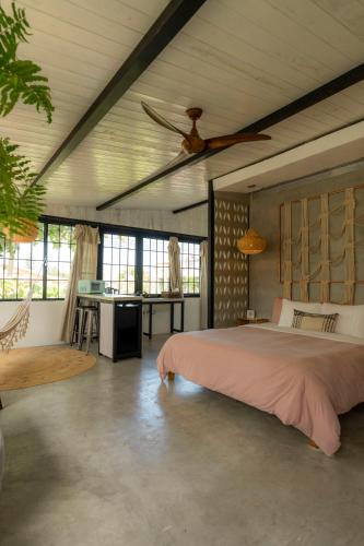 a bedroom with a large bed and a desk at Casa Botanica in San Juan