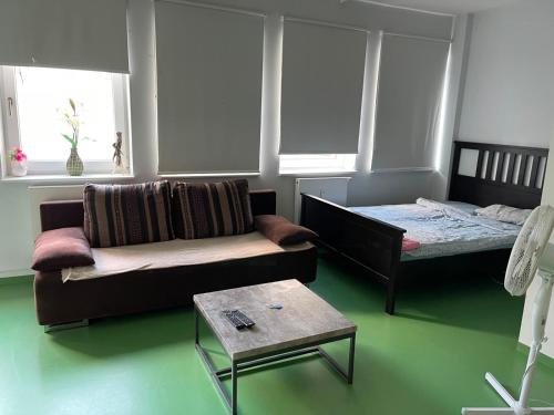a living room with a couch and a bed at Wiesbaden Apartment in Wiesbaden