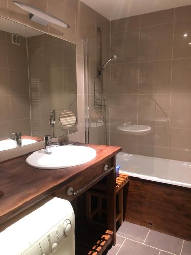 a bathroom with a sink and a shower and a tub at Tania nice chalettt garden view in Courchevel