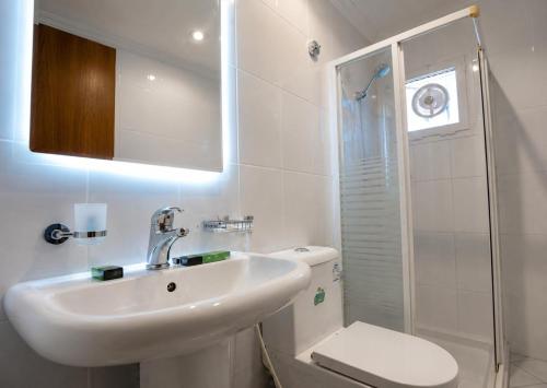 a bathroom with a sink and a toilet and a shower at سرايا الغربية للشقق المخدومة - saraya algharbiyya Establishment in Jeddah