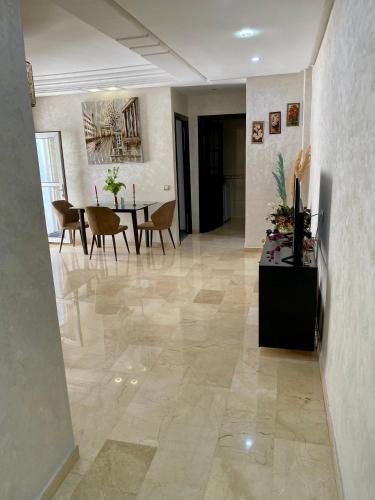 a hallway with a table and chairs in a room at Appartement de lux in Casablanca