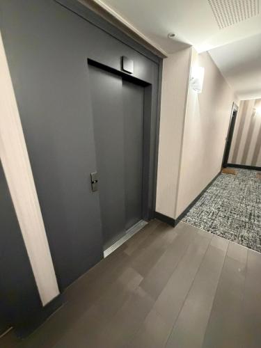 an empty hallway with a door in a building at Modern 2BR Train, Versailles, Paris in Plaisir