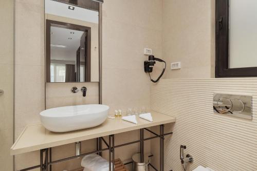 a bathroom with a white sink and a mirror at Viale in Budva