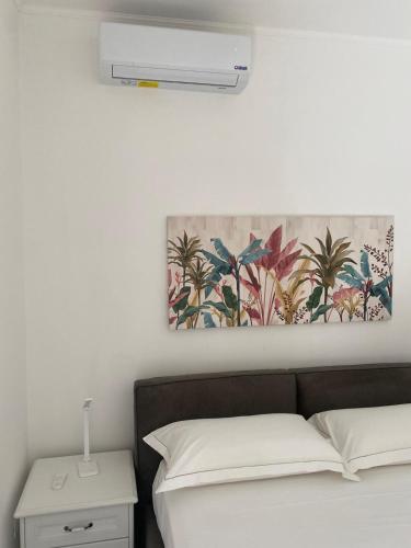 a bedroom with a bed with a air conditioner on the wall at Dietro La Torre in Lizzano