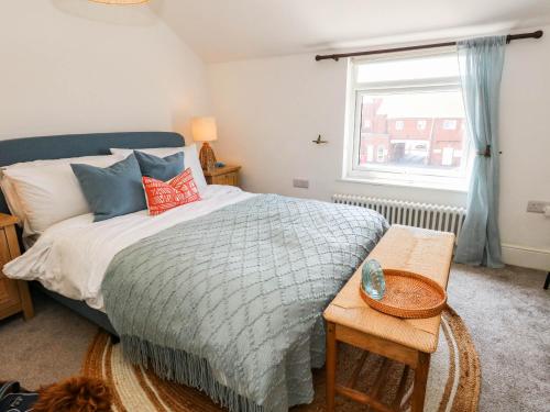a bedroom with a bed and a window at The Watch House in Weymouth