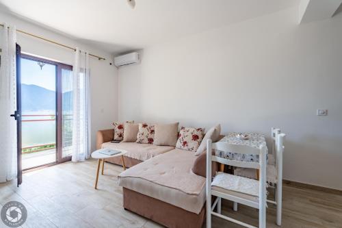 a living room with a couch and a bed at Bonaca Apartments in Kotor