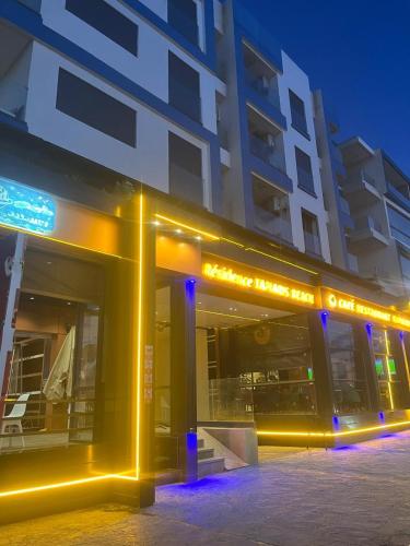 a building with yellow lights in front of it at Perle de LAtlantique in Kenitra