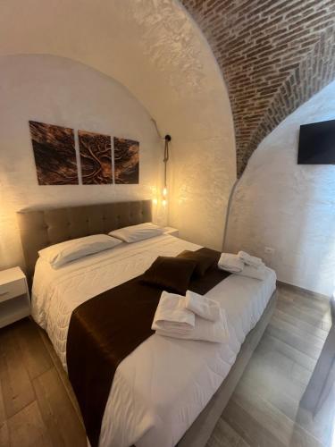 a bedroom with a bed with two towels on it at Mercato29Home in Lucera