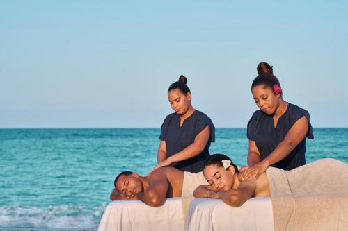 a group of people standing on the beach at Tropical Adventure Studios Suites HOTEL Beach CLUB & SPA in Punta Cana