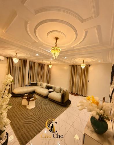 a large living room with a couch and a table at ChoCho Apartments in Limbe