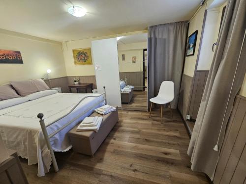 a bedroom with a bed and a chair in it at Locazione Turistica LBS, San Giacomo , Spoleto in San Giacomo