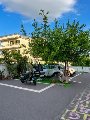 a scooter parked in a parking lot next to a car at Il vecchio Fauno in Pompei