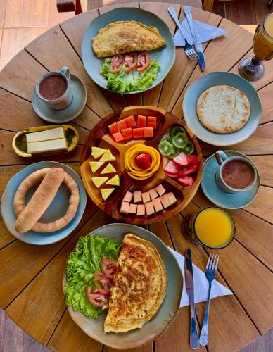 a wooden table with plates of food on it at La Colina Resort SAS in La Vega