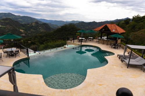 a swimming pool with a view of the mountains at La Colina Resort SAS in La Vega
