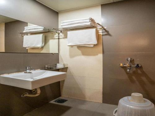 a bathroom with a sink and a mirror and a toilet at Hotel Royce By Glitz-Nxt to Visa Consulate & Kurla Station in Mumbai
