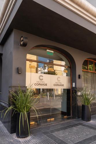 a store front of a building with a window at Hotel Copahue in Junín