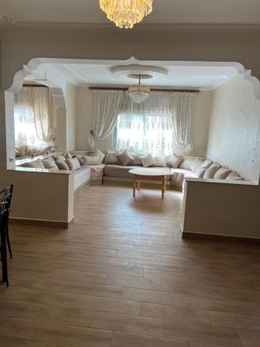 a living room with a couch and a table at Jad Moon Stay in Fnidek
