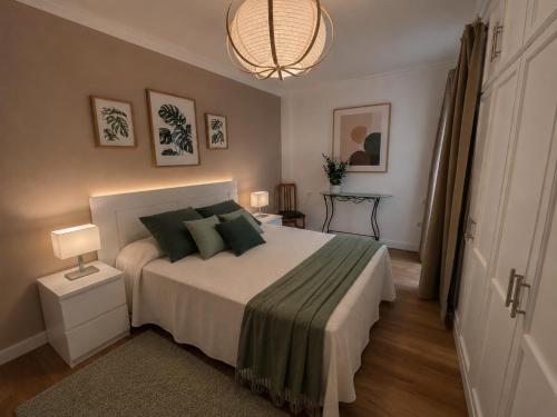 a bedroom with a bed and a chandelier at VV Vista a Teno in Buenavista del Norte