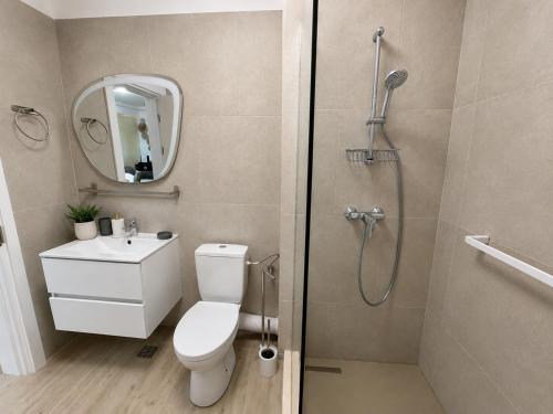 a bathroom with a shower and a toilet and a sink at INFINITY Sea View Luxury SUITE in Mamaia Sat/Năvodari
