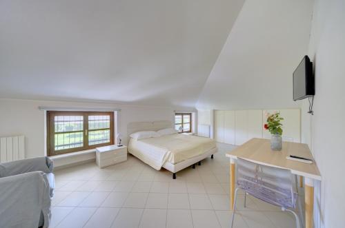 a bedroom with a bed and a desk in it at Villa dante in Alba