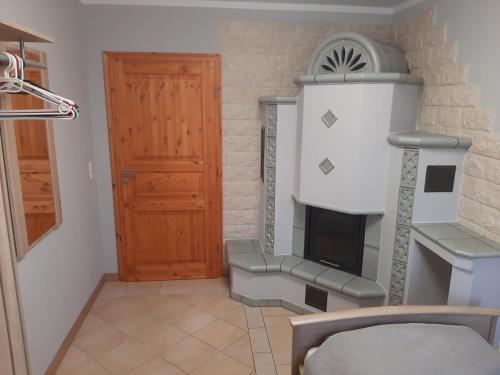 a room with a fireplace and a wooden door at Ferienwohnung Lilie in Pegau