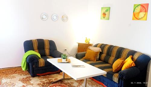 a living room with two chairs and a table at Bonita in Mostar