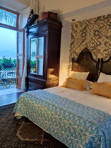 a bedroom with a large bed and a large window at La belle èpoque in Milazzo