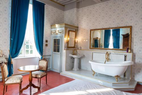 a bathroom with a tub and a sink at Chateau de Mons Gard prés d Uzes in Mons