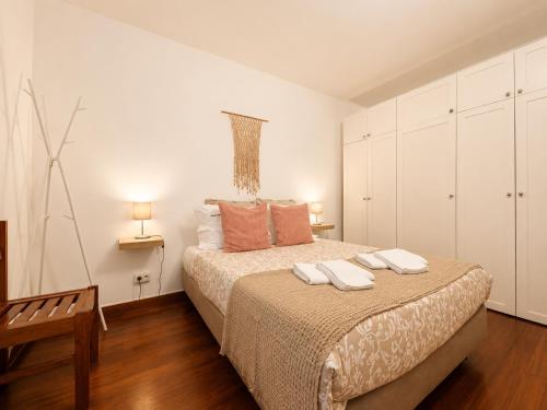 a bedroom with a bed with two towels on it at Studio Gerês in Geres