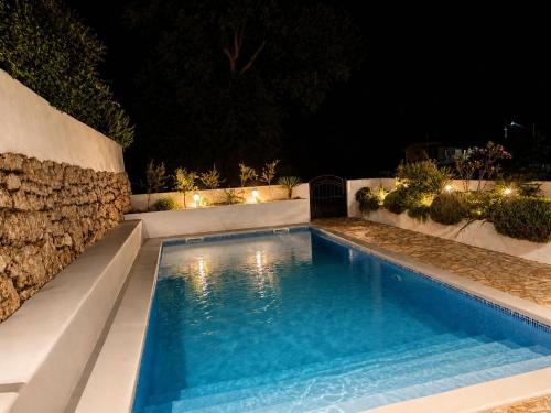 a swimming pool in a backyard at night at Villa "Lala" in Ljubuški