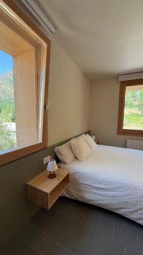a bedroom with a large bed and a window at La Francesa de Eriste in Sahun