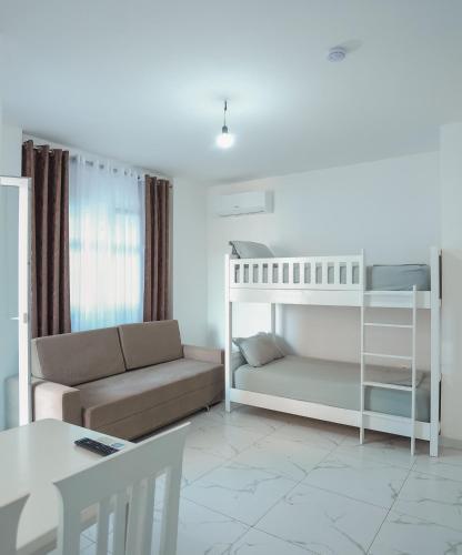 a living room with a bunk bed and a couch at EBIS HOTEL in Shëngjin