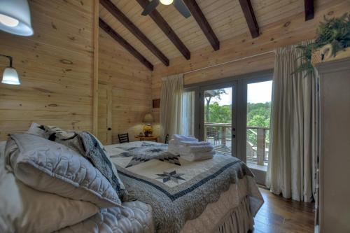 a bedroom with a bed and a large window at Blueberry Hill Fire Pit MTN Views Grill in McCaysville