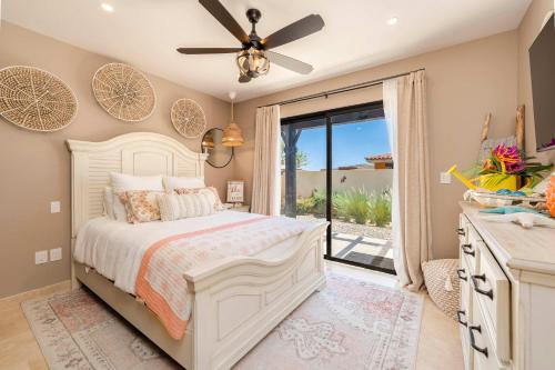 a bedroom with a bed with a ceiling fan at Luxury House with Ocean View in Cabo San Lucas