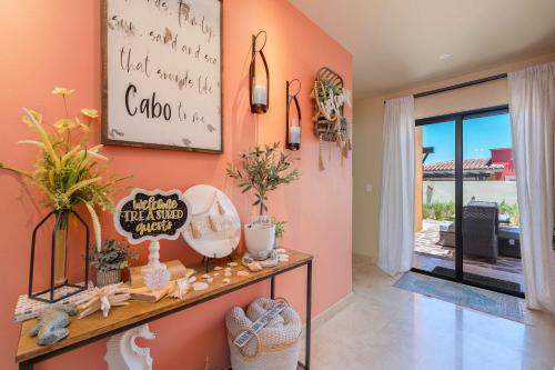 a room with orange walls and a shelf with items on it at Luxury House with Ocean View in Cabo San Lucas