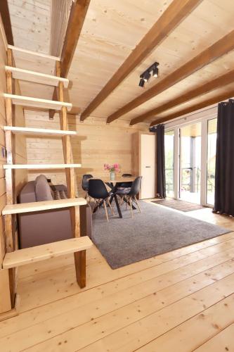 a room with a spiral staircase in a wooden house at Diamond chalet in Ogrody