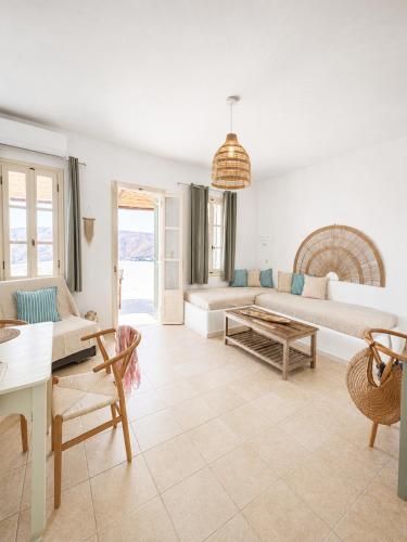 a living room with a couch and a table at Uranos studios Amorgos in Amorgos