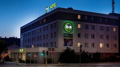 a building with a sign on the top of it at B&B HOTEL Kielce Centrum in Kielce