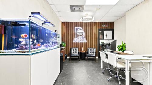 an office with an aquarium and a table and chairs at Girasole Suites in Miami Beach