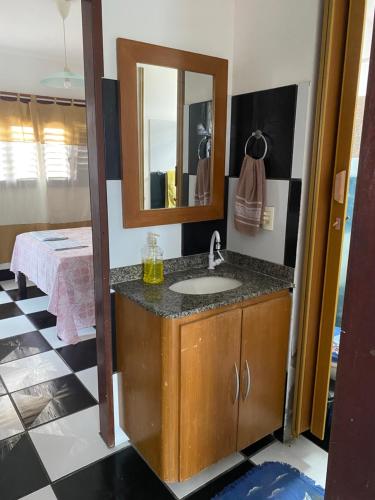 a bathroom with a sink and a mirror at Apartamento in Natal