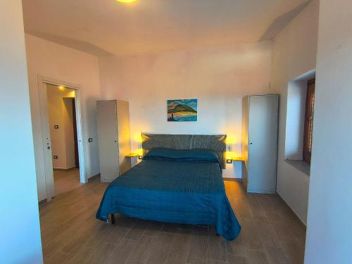 a bedroom with a bed with a blue blanket at Il Ligustro Terrace in Casal Sottano