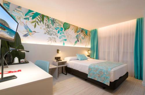 a hotel room with a bed and a desk at Hotel Tropical in San Antonio