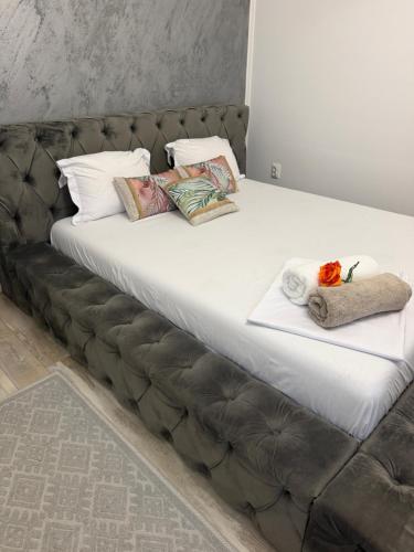 a bed with two pillows on top of it at The cozy escape in Satu Bucovei