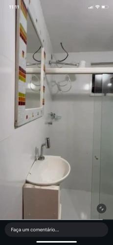 a bathroom with a sink and a mirror at Pouso do Caiçara suíte in Paraty