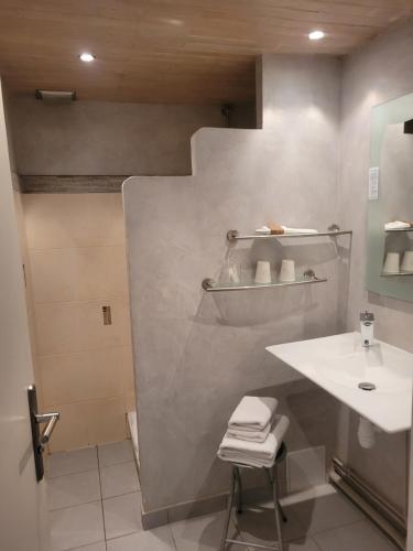 a white bathroom with a sink and a toilet at Bomotel in Montluçon