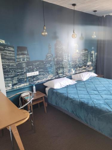 a bedroom with a bed and a city skyline at Bomotel in Montluçon