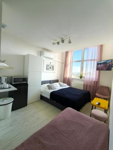 a hotel room with a bed and a window at MALTINA in Malbork
