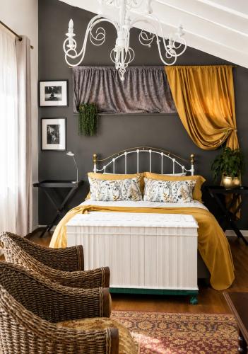 a bedroom with a bed and a chandelier at Gadute Haven - Luxury Apartment in Pretoria