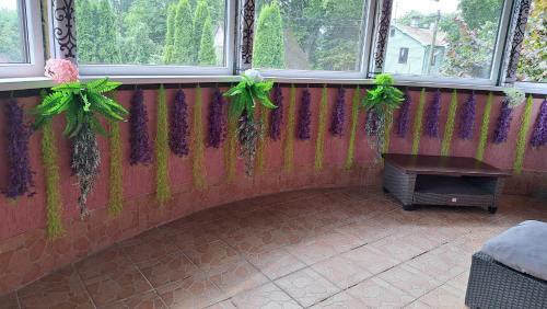a room with two windows with green bows at APPLE PARADISE, House of mirrors, self check-in, FREE PARKING in Riga