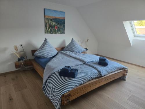 a bedroom with a bed with two pillows on it at Ferienwohnung Unterallgäu in Markt Rettenbach